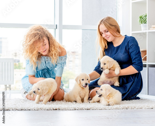 Girls playing with puppies