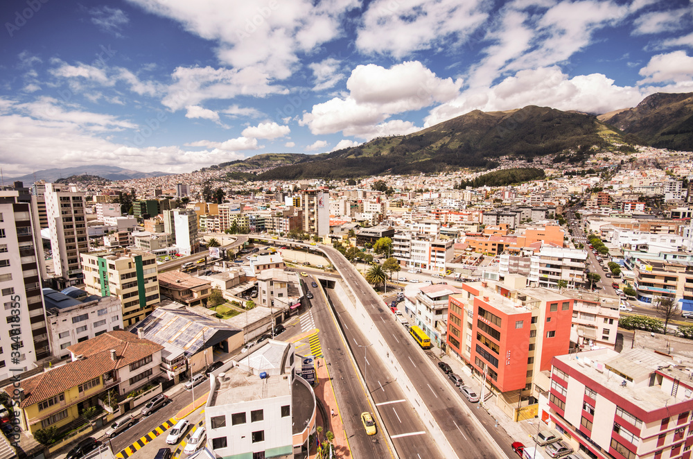 Beautiful view from modern part of Quito mixing new architecture with charming streets, north part of the city of Quito, Ecuador with a mountain in the horizont