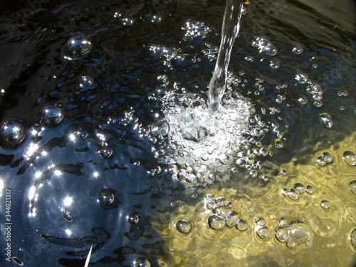 Waterstream with sun reflections photo