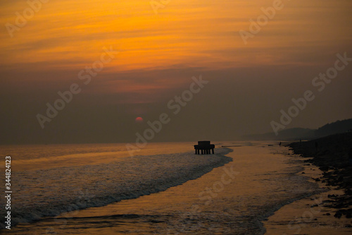 Beautiful sunset on indian sea beach at digha photo