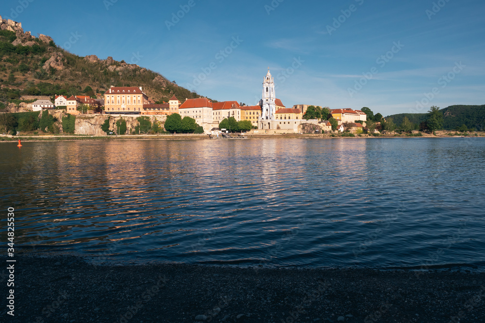 Duernstein Cityscape with Blue and White Baroque Abbey Church Tower, located on the River Danube in Wachau Valley, Austria in the Evening