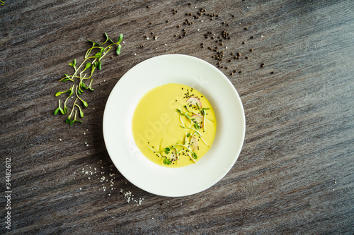 woman eating yellow vegetables cream soup