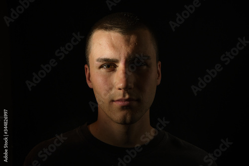 Dark and dramatic portrait of a serious and professional young man 