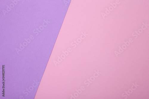Pink and purple paper as background. Two colored pastel paper texture, top view with place for text