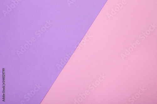 Pink and purple paper as background. Two colored pastel paper texture, top view with place for text