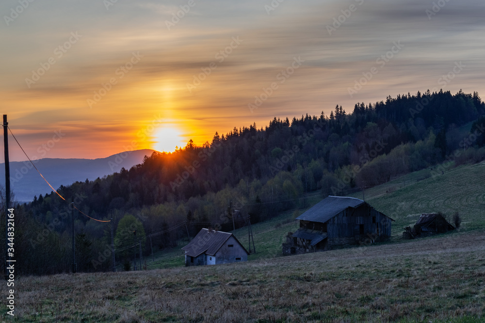 Mountain landscape with wooden hut during sunrise time. Shot in Poland, Sudetes Mountains. 