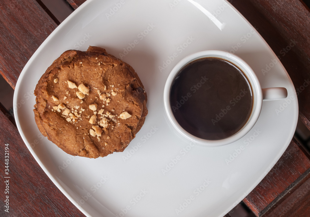 cookies and coffee on the wooden desk cookies and coffee on the wooden desk