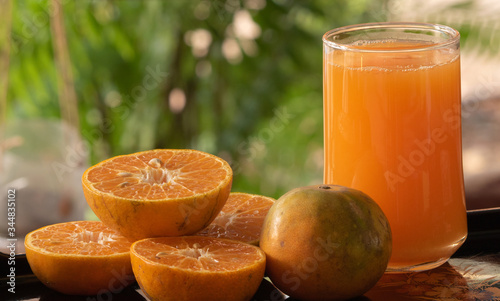 Squeezed orange juice with half oranges