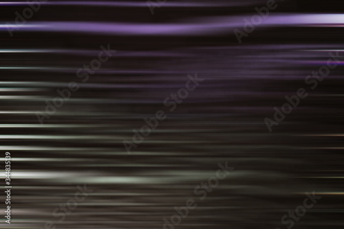 abstract background , purple  and gray glowing  lines in the horizontal direction on the dark