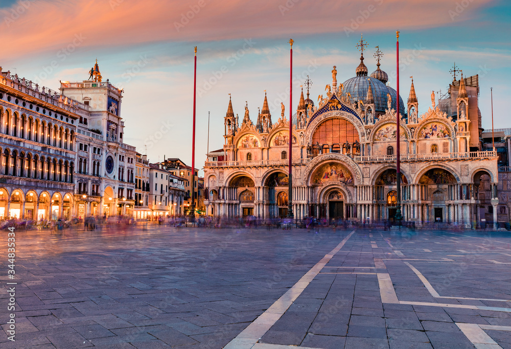 Fantastic sanset on San Marco square with Saint Mark's Basilica. Spectacular evening cityscape of Venice, Italy, Europe. Traveling concept background.