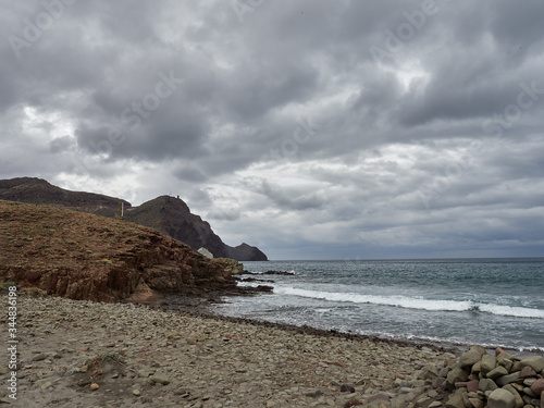 Rocky beach with storm clouds at Cabo de Gata, Almeria, Spain