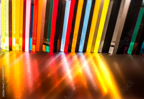 light through Stack of different colours Cast Acrylic Sheet on black background photo