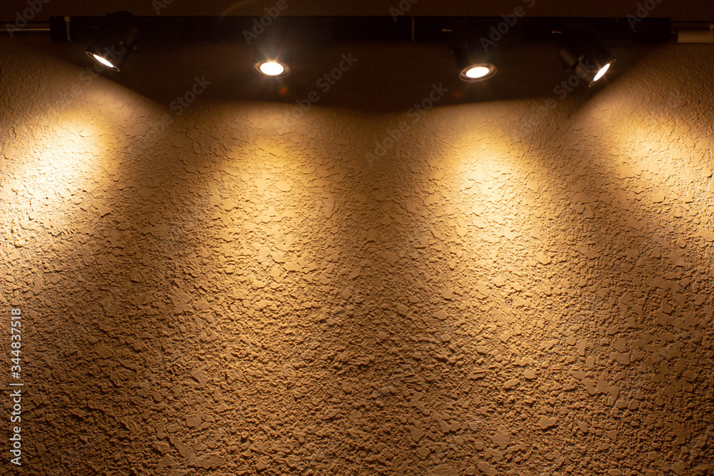 yellow rough wall with down spot light