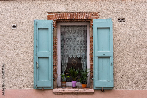 Saint Sulpice, France - August 2013: quaint window in terraced house