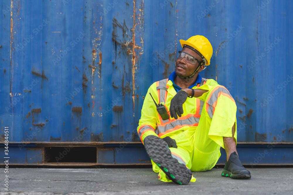 Foreman logistic staff sitting relax on the floor at Cargo container shipping Foreman logistic staff sitting relax on the floor at Cargo container shipping