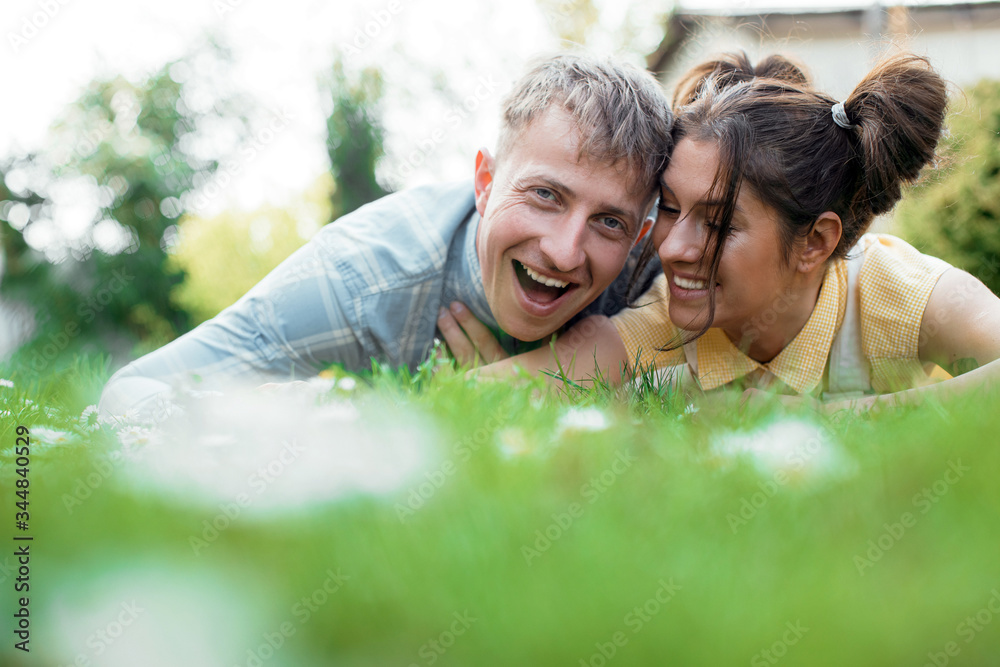 Couple in love. Happy couple lying on grass. Honeymoon. Love photo. Couple in love. Happy couple lying on grass. Honeymoon. Love photo.