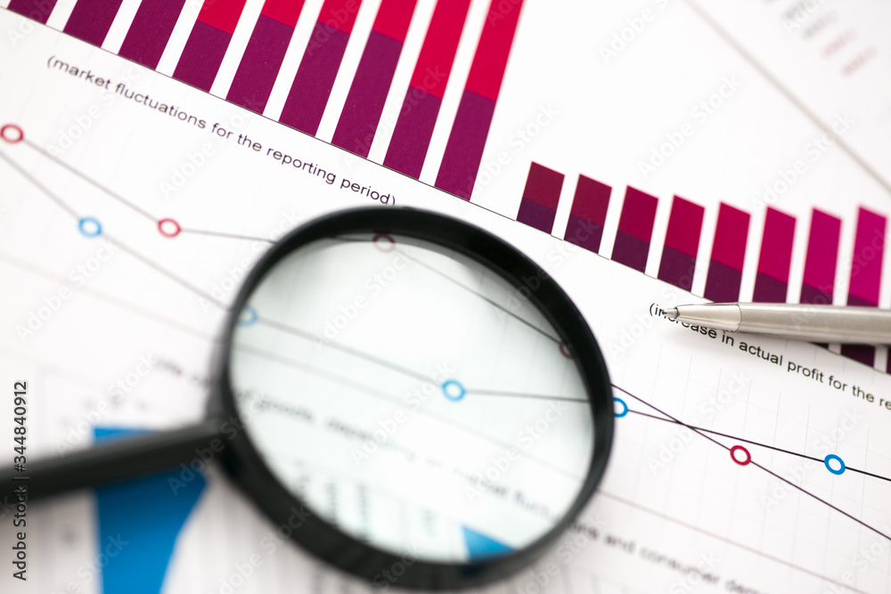 Financial statistics documents on lens and pen office table closeup. Internal Revenue Service inspector sum check, irs investigation, exchange market, earnings, savings, loan and credit concept Financial statistics documents on lens and pen office table closeup. Internal Revenue Service inspector sum check, irs investigation, exchange market, earnings, savings, loan and credit concept