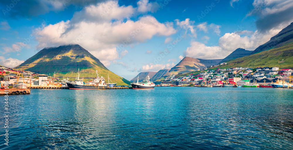 Panoramic morning view of Klaksvik port, Bordoy island. Picturesque summer scene of fjord on Atlantic ocean. Beautiful landscape of Faroe Islands, Kingdom of Denmark, Europe.