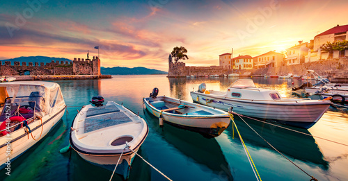 Fototapeta Naklejka Na Ścianę i Meble -  Great evening view of Gulf of Corinth, Greece, Europe. Attractive sunset on popular touristic destination - Nafpaktos port. Calm seascape of Ionian sea. Traveling concept background.