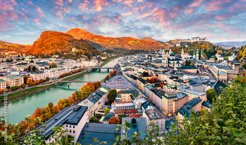 Attractive evening cityscape of Salzburg, Old City, birthplace of famed composer Mozart. Aerial autumn scene of Eastern Alps.Splendid landscape with Salzach river. Traveling concept background.
