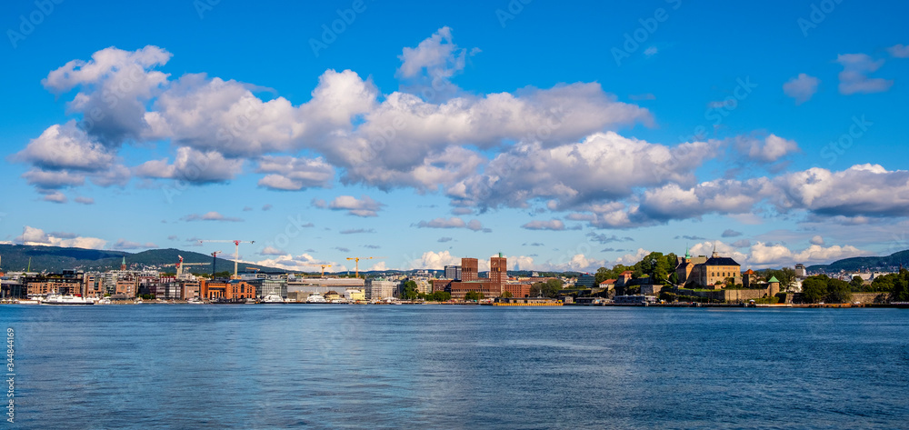 Oslo, Norway - Panoramic view of Oslo waterfront with Akershus Fortress, City Hall and Aker Brygge borough at Pipervika harbor