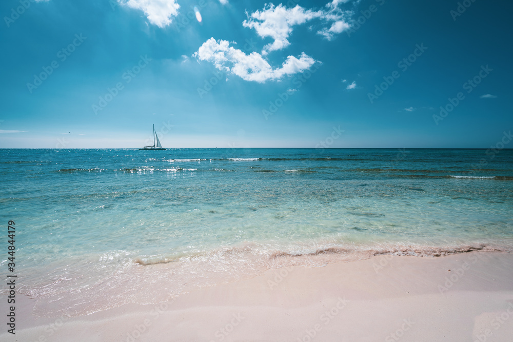 caribbean paradise beach with white sand & turquoise water with sailing ship, Isla Saona, Dominican Republic