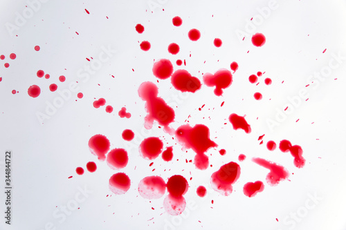 Many drops of blood on a white background 