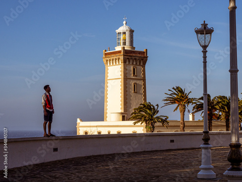 A man looking at Cape Spartel lighthouse in Tangier