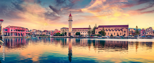 Panoramic summer cityscape of Zakynthos city. Fantastic sunset scene of town hall and Saint Dionysios Church, Ionian Sea, Zakinthos island, Greece, Europe. Traveling concept background.