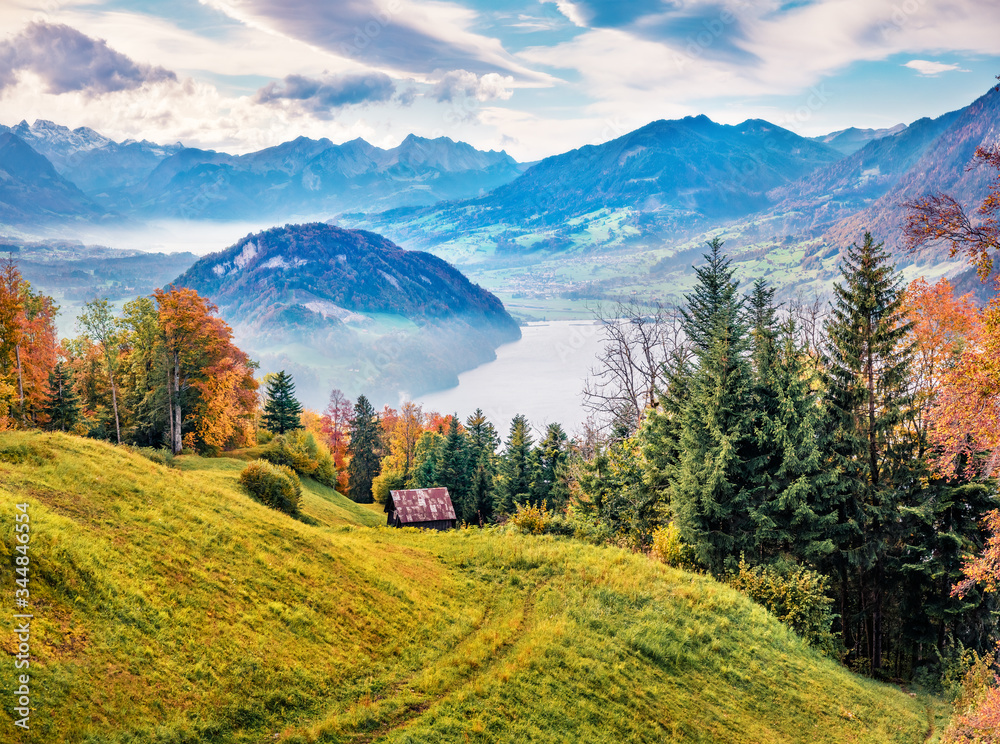 Misty morning view of outskirts of  Stansstad town, Switzerland, Europe. Captivating autumn scene of  Lucerne lake. Wonderful landscape of Swiss Alps. Traveling concept background.