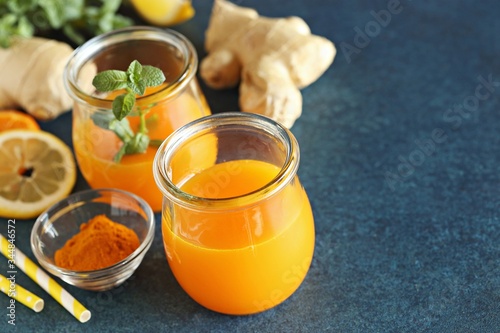 Ginger shot with citrus fruits juice, turmeric and honey. Flat layot, copy space