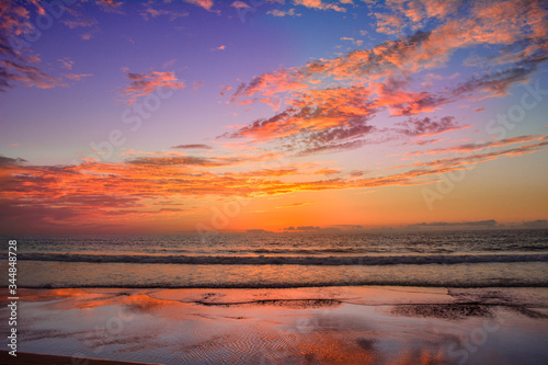 Cloudy and orange sunset on the seashore © Valentina