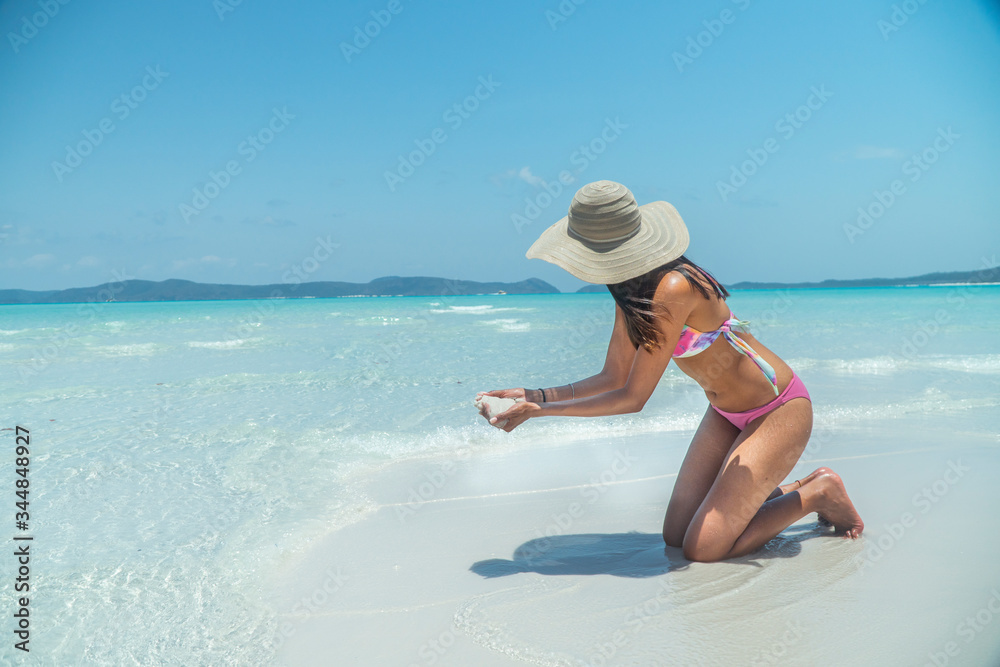Woman holding white beach sand. Famous white silica sand. Whitehaven beach, Whitsundays. Turquoise ocean, white sand. Travel, holiday, vacation, paradise. Shot in Hill Inlet, Queenstown, Australia. Woman holding white beach sand. Famous white silica sand. Whitehaven beach, Whitsundays. Turquoise ocean, white sand. Travel, holiday, vacation, paradise. Shot in Hill Inlet, Queenstown, Australia.