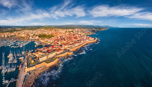 View from flying drone. Wonderful summer cityscape of Alghero port, Province of Sassari, Italy, Europe. Incredible evening scene of Sardinia island, Mediterranean seascape.