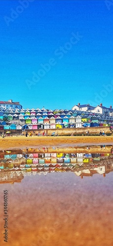 Stock photo of a colourful view of the sea shore of the Essex small town Walton-on-the-Naze reflected in the sea water, with copy space.