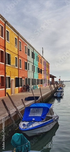 Stock photo of  with Burano (Venice) coloured houses and boats parked in front of them with copy space available. © Cosmin