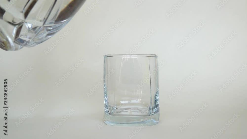Pour water into a glass glass of vase on a white background Pour water into a glass glass of vase on a white background