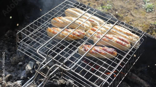 Kupaty sausages on a grill. Kupaty was made from chicken and pork, intestines, pepper, onions and other spices. Stay home with family and cook barbecue during May holidays and the coronavirus pandemic photo