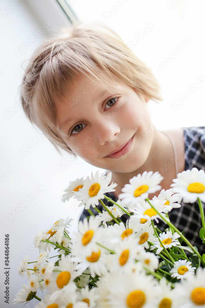 short-haired little girl with bouquet of camomiles short-haired little girl with bouquet of camomiles