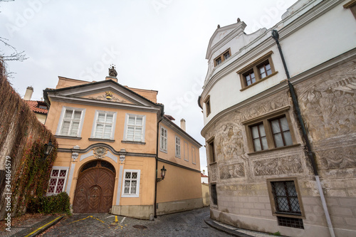 Empty picturesque cobblestone medieval and narrow street of Hradcany hill in Prague, Czech Republic, with medieval houses. It is a major touristic attraction.