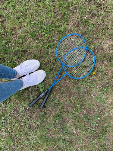 Badminton racket game in summer. Active outdoor sports. Summer gambling in nature. Sport on the grass. Weekend on the mountains.