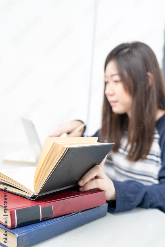 Young female sitting in living room and learning online Young female sitting in living room and learning online