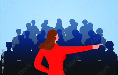 Female leader standing in front of a group of people speaking