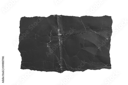 Black crumpled torn paper page. Isolate on a white background. Dusty shabby folds. For design and titles.