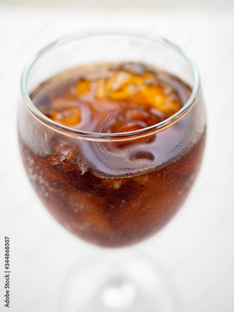 Cola soft drinks are in the glass.
have Drop of water Glass round,White Background Cola soft drinks are in the glass.
have Drop of water Glass round,White Background