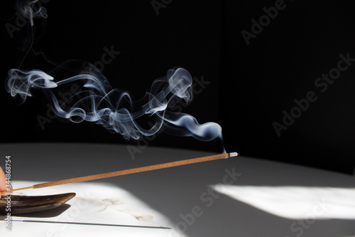 smoke incense stick on black background home meditation anti stress concept