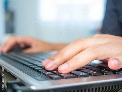 Woman's hand is pressing the keyboard,Work form home during the virus epidemic