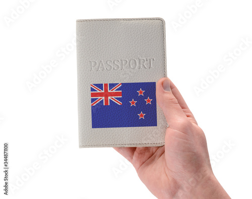 New Zealand passport in a man's hand on white background