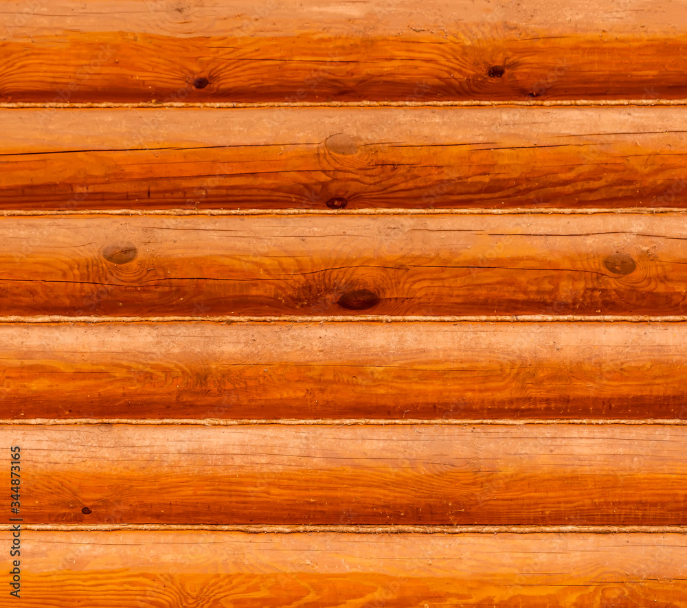 Obraz premium Wooden wall from logs of pine , nature lumber background texture , ginger wood surface backdrop
