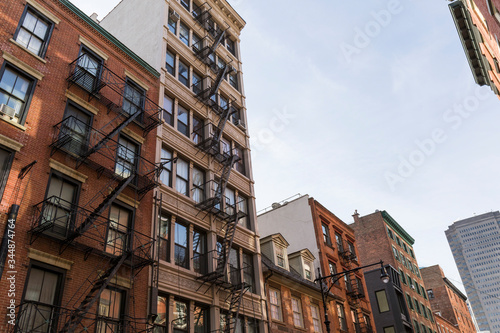 fire escape stairs on brick building facades in New York
